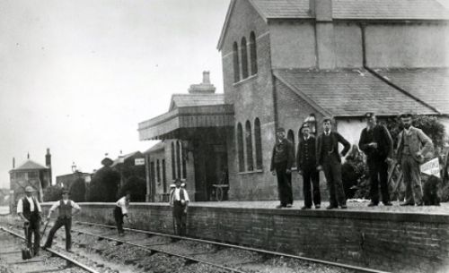 Vintage photograph of Alresford railway station with workers (Photo courtesy of The Mid Hants Railway Watercress Line)
